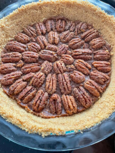 This Healthy Maple Pecan Pie is naturally sweetened and makes a delicious dessert for your table! It can be made vegan and gluten-free with swapping butter for coconut oil and using gluten-free graham crackers or cookies for the pie crust.