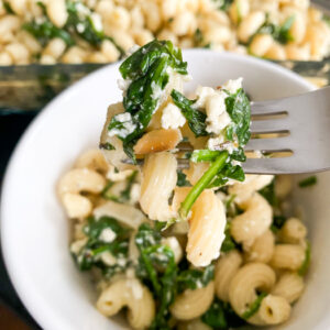 This Baked Spinach and Feta Pasta is a warm and creamy take on classic Greek Spanakopita. It's made with fresh baby spinach, a block of feta cheese, and many other delicious flavors!