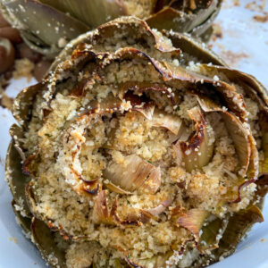 Artichokes are super healthy so they can be a great addition or star of any dinner! This recipe fills the hearty artichokes with a delicious blend of flavors and spices. They're stuffed with breadcrumbs, onions, garlic, parmesan cheese and more!